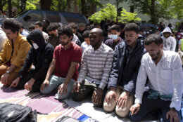 George Washington University students pray on the street after police close the students plaza during a pro-Palestinian protest over the Israel-Hamas war, Friday, April 26, 2024, in Washington. (AP Photo/Jose Luis Magana)