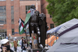 A statue of George Washington draped in a Palestinian flag and a keffiyeh is seen at George Washington University as students demonstrate on campus during a pro-Palestinian protest over the Israel-Hamas war on Friday, April 26, 2024, in Washington. (AP Photo/Jose Luis Magana)