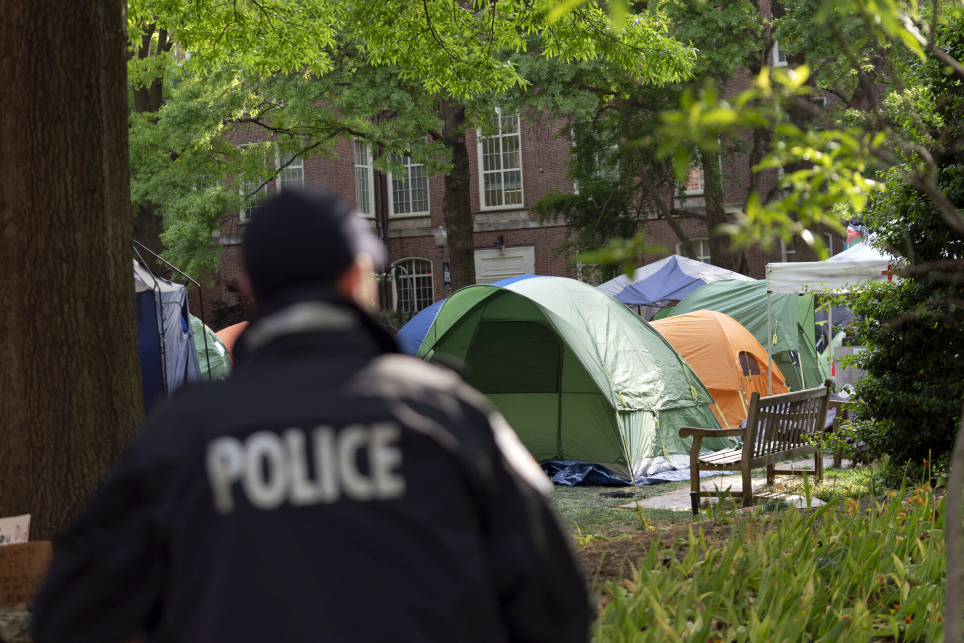 George Washington University police officers scan the area as students demonstrate on campus during a pro-Palestinian protest over the Israel-Hamas war on Friday, April 26, 2024, in Washington. (AP Photo/Jose Luis Magana)